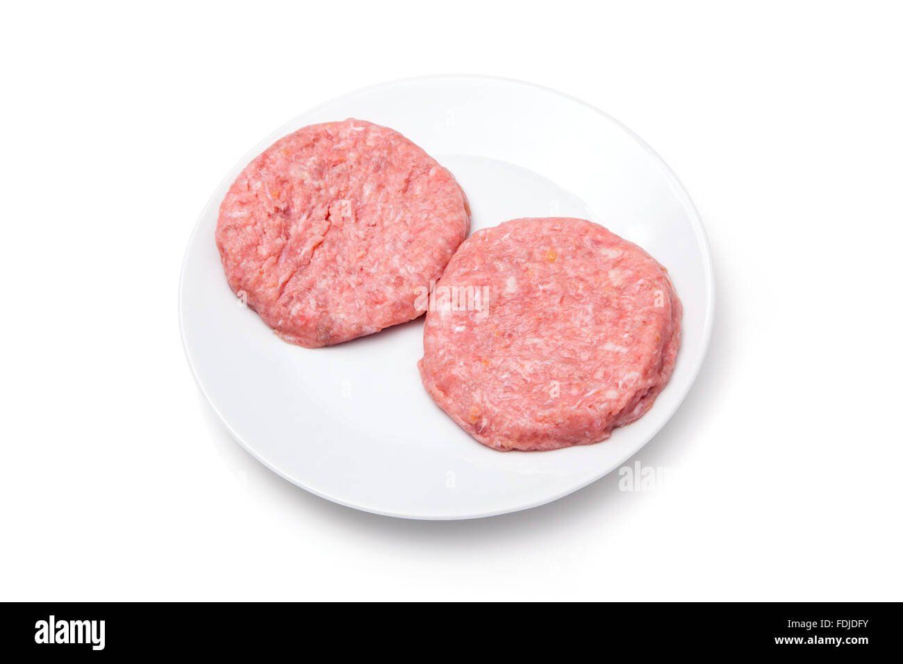 Raw crocodile meat burgers isolated on a white studio background. Stock Photo