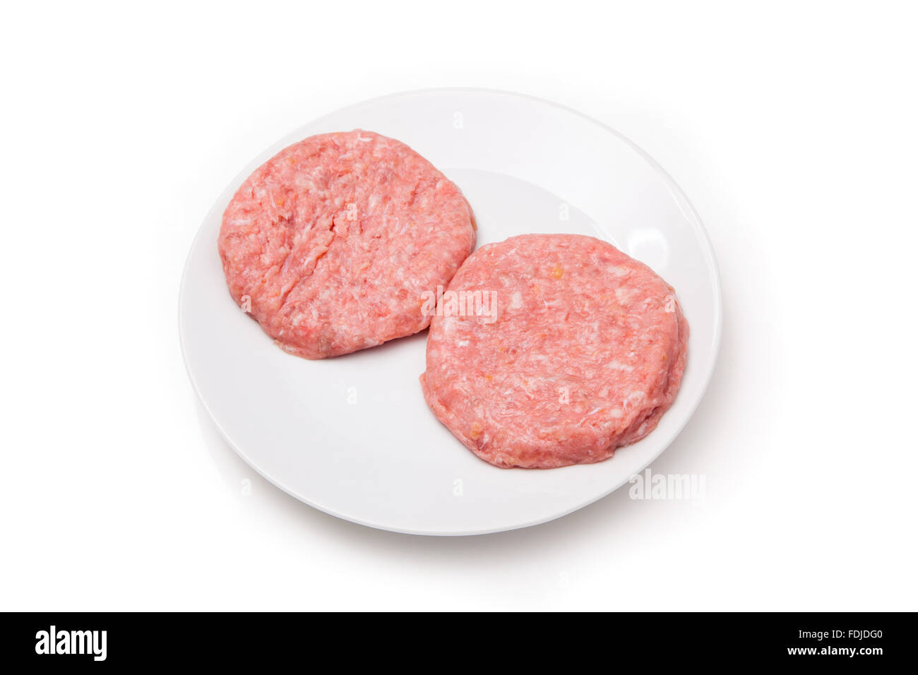 Raw crocodile meat burgers isolated on a white studio background. Stock Photo