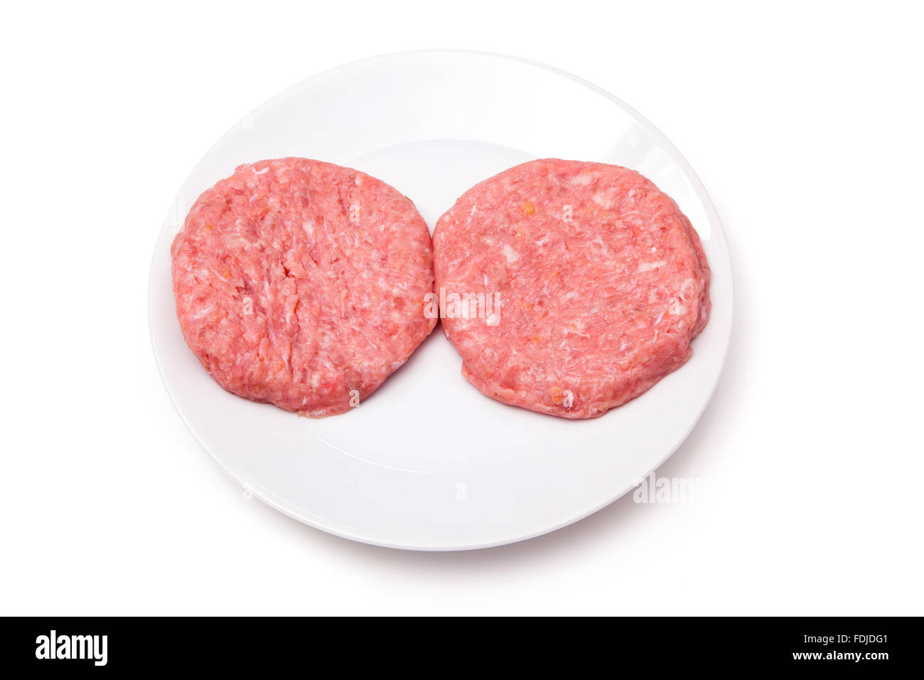 Raw crocodile meat burgers isolated on a white studio background. Stock Photo