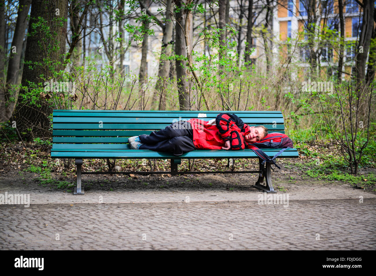 Homeless man sleeping on park bench in Berlin Stock Photo Alamy