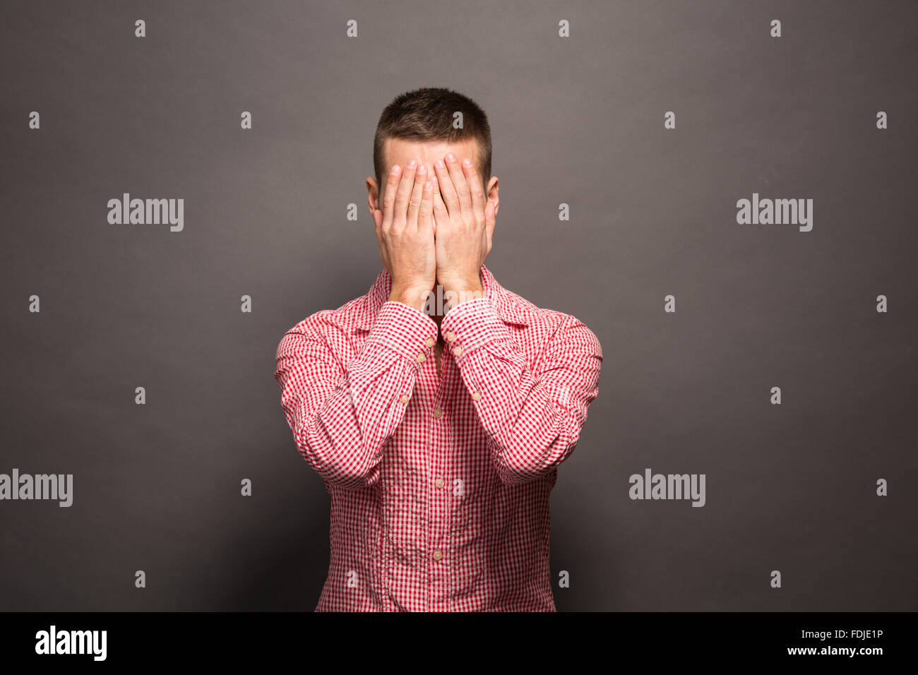 Man covering eyes his face Stock Photo Alamy