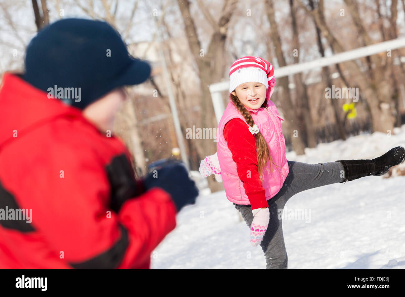 Cute girl of school age having fun in winter park Stock Photo