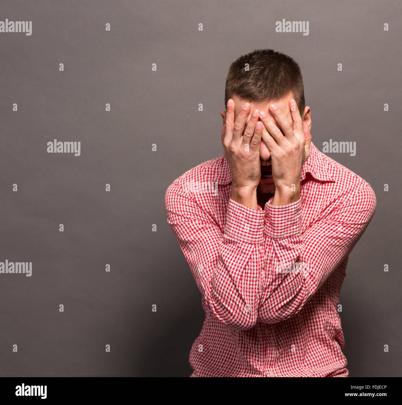Man covering eyes his face Stock Photo - Alamy