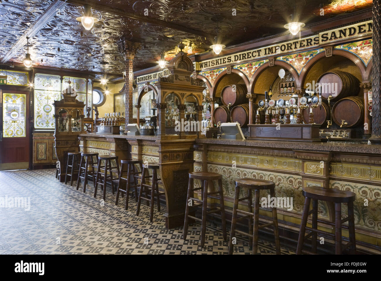 A view inside The Crown Bar, Great Victoria Street, Belfast. Formerly known as the Crown Liquor Saloon, the pub building dates from 1826 but the wonderful late Victorian craftsmanship of the tiling, glass and woodwork undertaken by Italian workers dates f Stock Photo