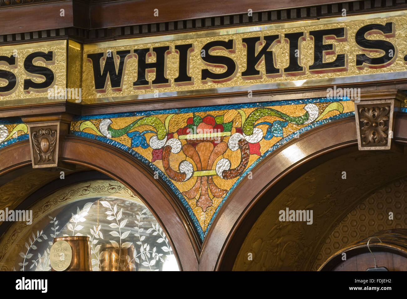 Decoration above the bar at The Crown Bar, Great Victoria Street, Belfast. Formerly known as the Crown Liquor Saloon, the pub building dates from 1826 but the wonderful late Victorian craftsmanship of the tiling, glass and woodwork undertaken by Italian w Stock Photo