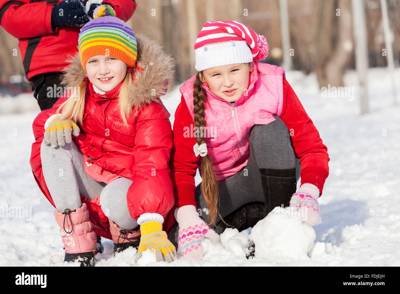 Children in winter park having fun and playing snowballs Stock Photo ...