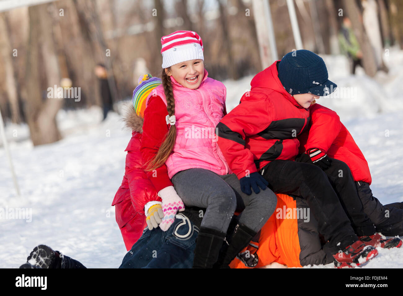 Children in winter park having fun and playing snowballs Stock Photo ...