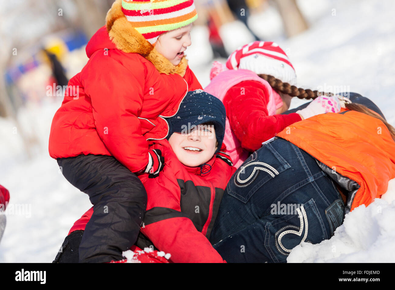 Children in winter park having fun and playing snowballs Stock Photo ...