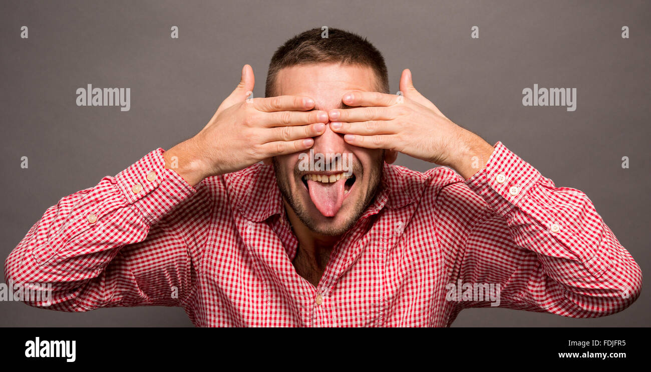 Man covering eyes with hands Stock Photo - Alamy