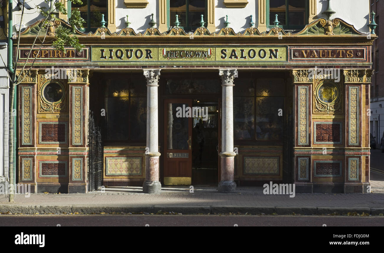 Street frontage of The Crown Bar, Great Victoria Street, Belfast. Formerly known as the Crown Liquor Saloon, the pub building dates from 1826 but the wonderful late Victorian craftsmanship of the tiling, glass and woodwork undertaken by Italian workers da Stock Photo