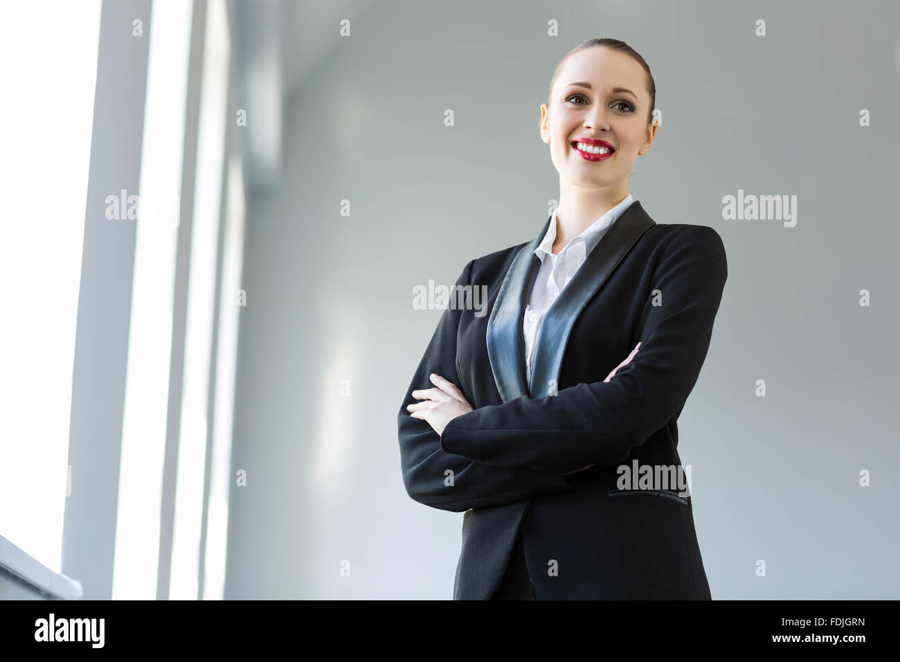 Image of young attractive businesswoman in business suit smiling Stock ...