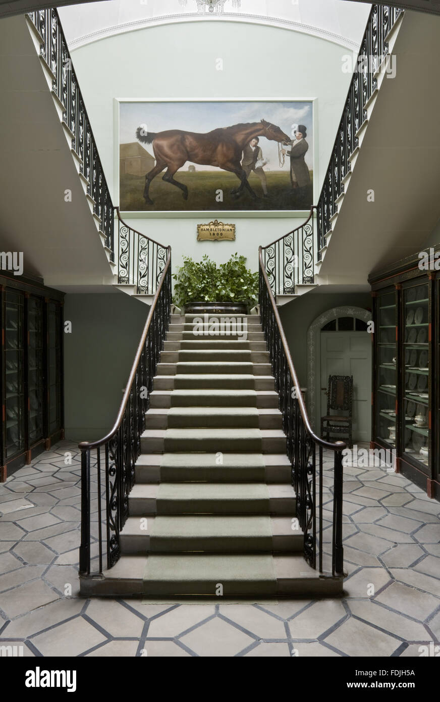 The Staircase, designed by George Dance, at Mount Stewart House, Co. Down, Northern Ireland. George Stubbs' famous painting of the racehorse Hambletonian hangs on the half-landing. Stock Photo