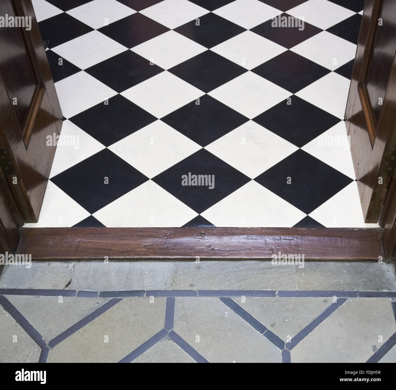 The meeting of the floors of the Hall with black and white linoleum and the Black and White Hall with grey stone floor, at Mount Stewart House, Co. Down, Northern Ireland. Stock Photo