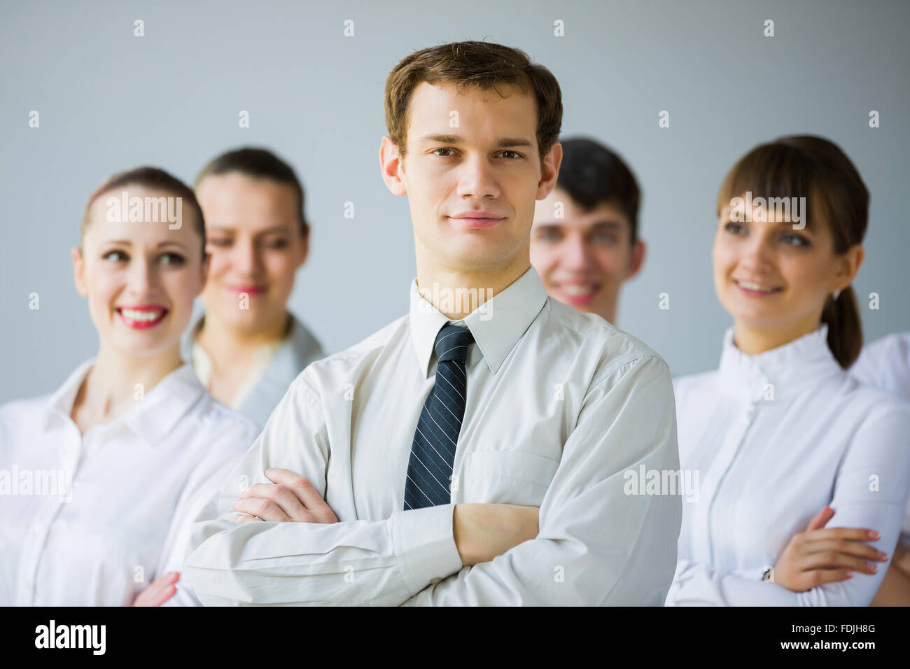 Young business people standing with arms crossed on chest Stock Photo