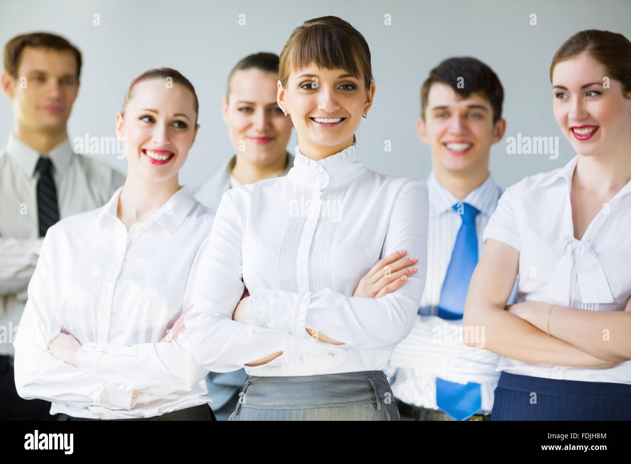 Young business people standing with arms crossed on chest Stock Photo ...