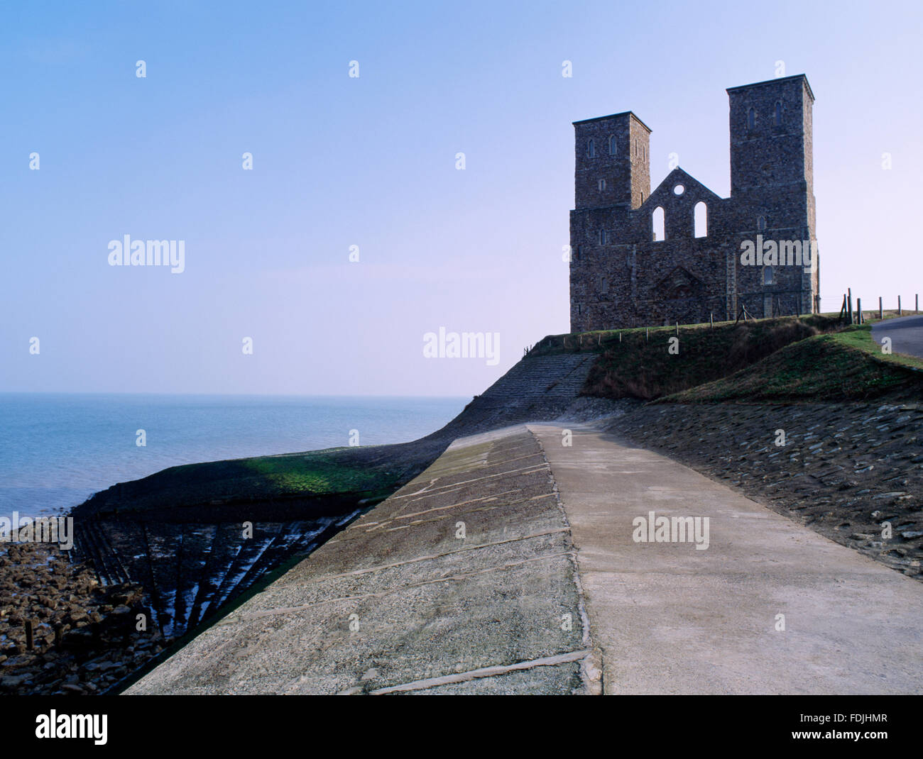 St Mary's Church, Reculver. The twin towers of the west front of the Norman church built within the Roman fort seen from the sea defences. Stock Photo