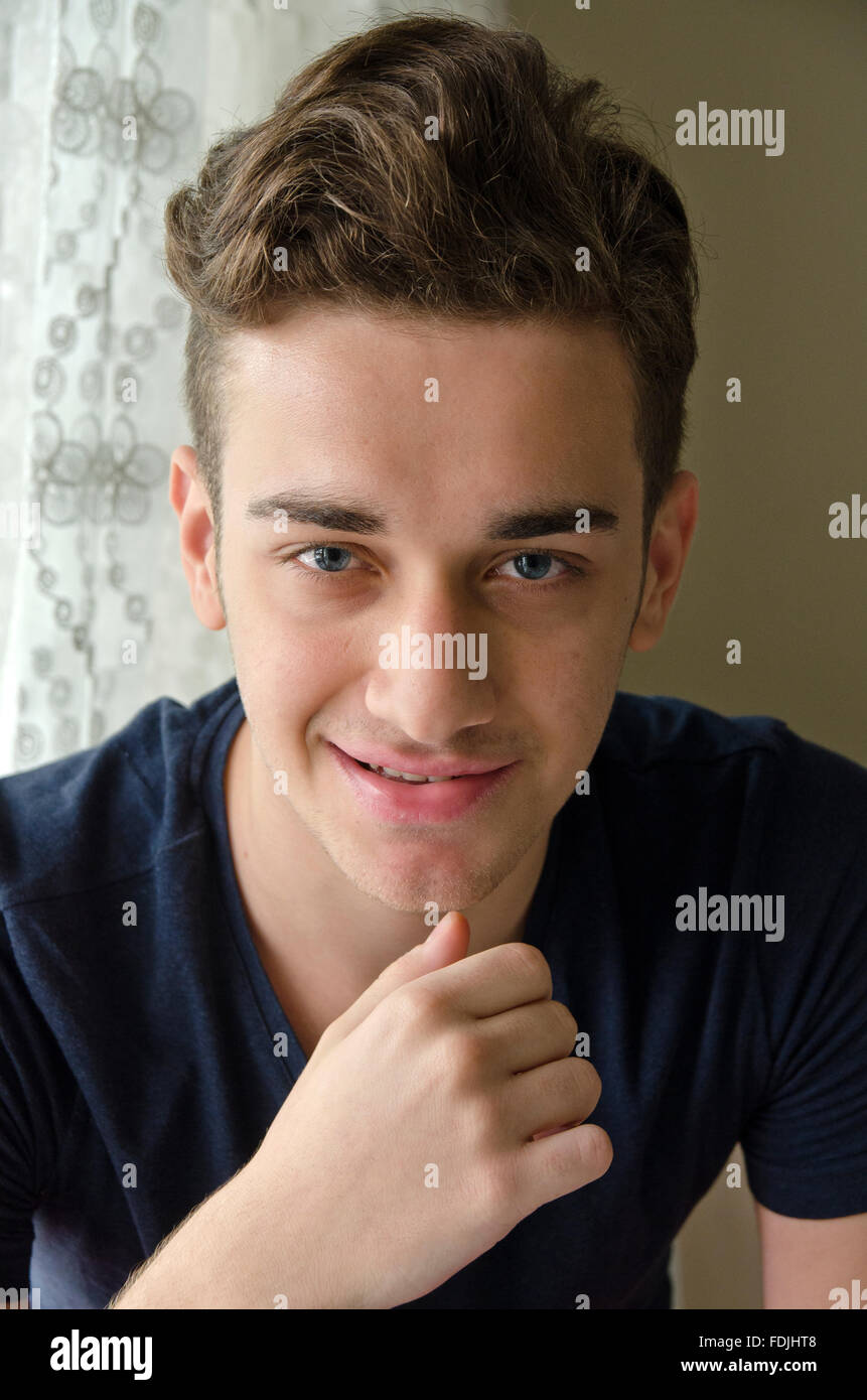 Eighten years old turkish young man smiling softly,head and shoulder pose Stock Photo