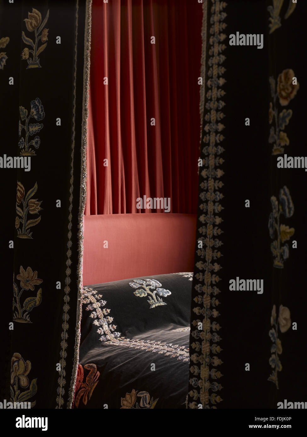 Close view of the black velvet bed hangings in the Mary, Queen of Scots' Room at Hardwick Hall, Derbyshire. The existing black velvet is nineteenth-century but is mounted with flowers and borders of Elizabethan embroidery.  Despite the name, it seems cert Stock Photo
