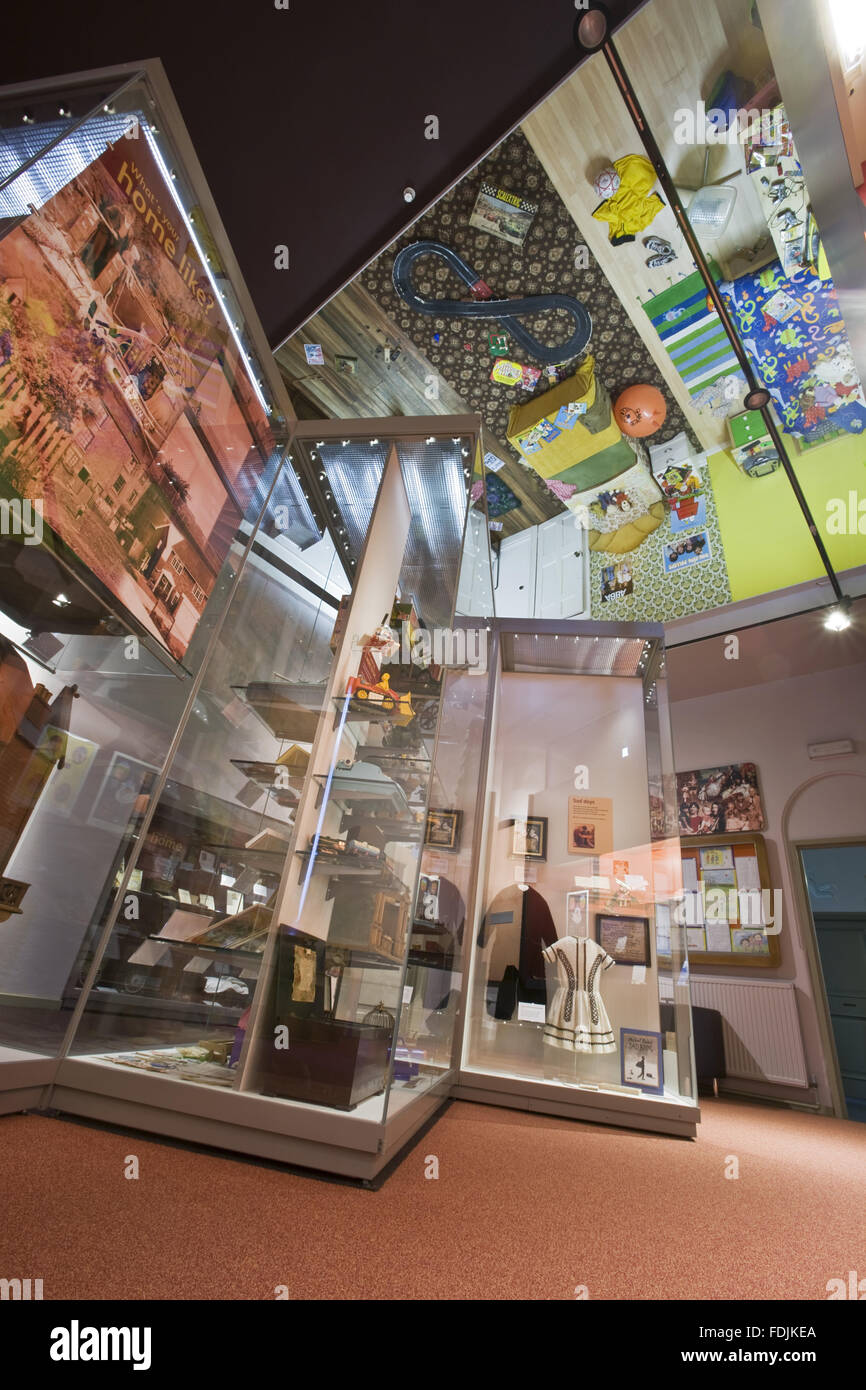 The Home Gallery showing display cabinets and the 'upside-down' room on the ceiling at The National Trust Museum of Childhood at Sudbury Hall, Derbyshire. Stock Photo