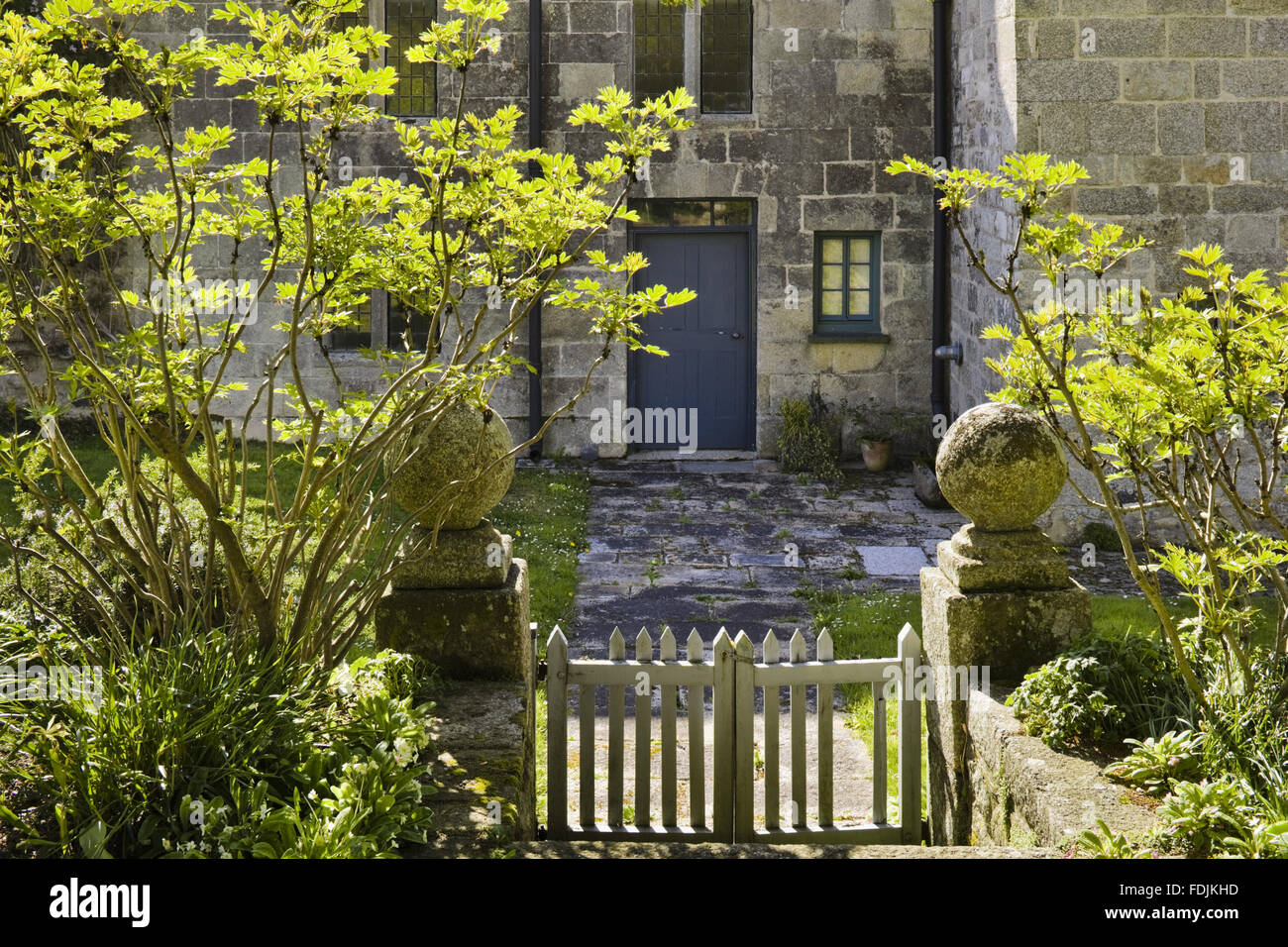 Wooden gate leading to the east side of the house at Godolphin House, once the home of Queen Anne's Lord High Treasurer, Sidney Godolphin, near Helston, Cornwall. The original fortified house was replaced in the fifteenth-century and later additions made Stock Photo