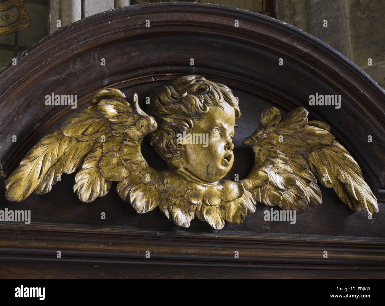 Carved wooden angel's head and wings on the seventeenth-century woodwork in the Chapel at Petworth House, West Sussex. Stock Photo