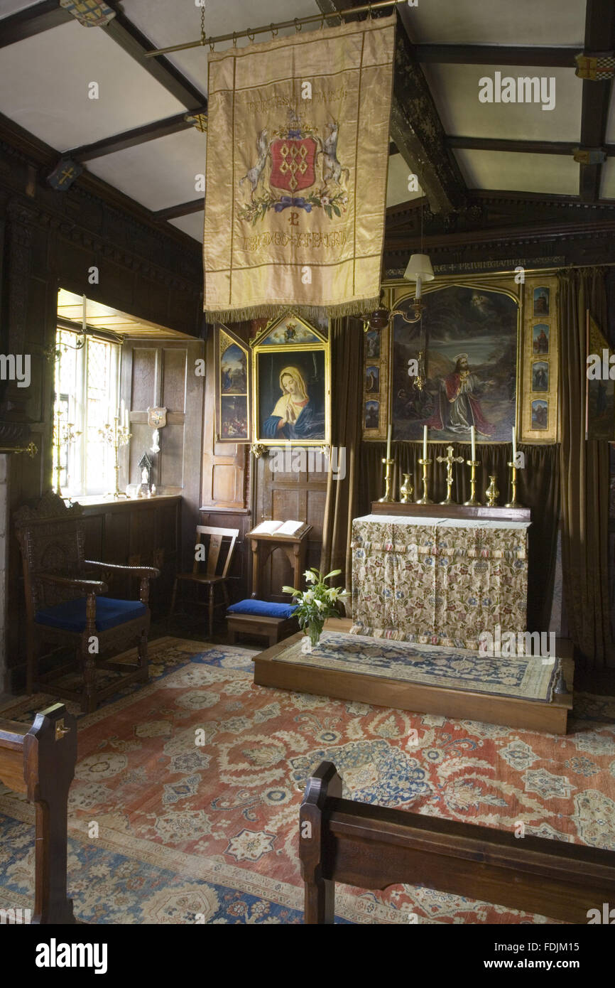 The Chapel at Baddesley Clinton, West Midlands, looking towards the altar. The room was created in its present form by Thomas Ferrers in 1940, based on photographs of 1875. The reredos painting is by Rebecca Ferrers of CHRIST IN THE GARDEN OF GETHSEMANE f Stock Photo