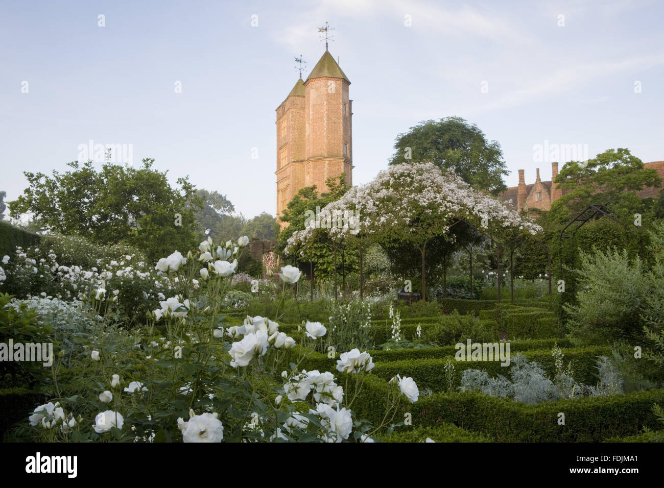 The White Garden in summer, with the Elizabethan Tower in the distance at Sissinghurst Castle Garden, near Cranbrook, Kent. Stock Photo