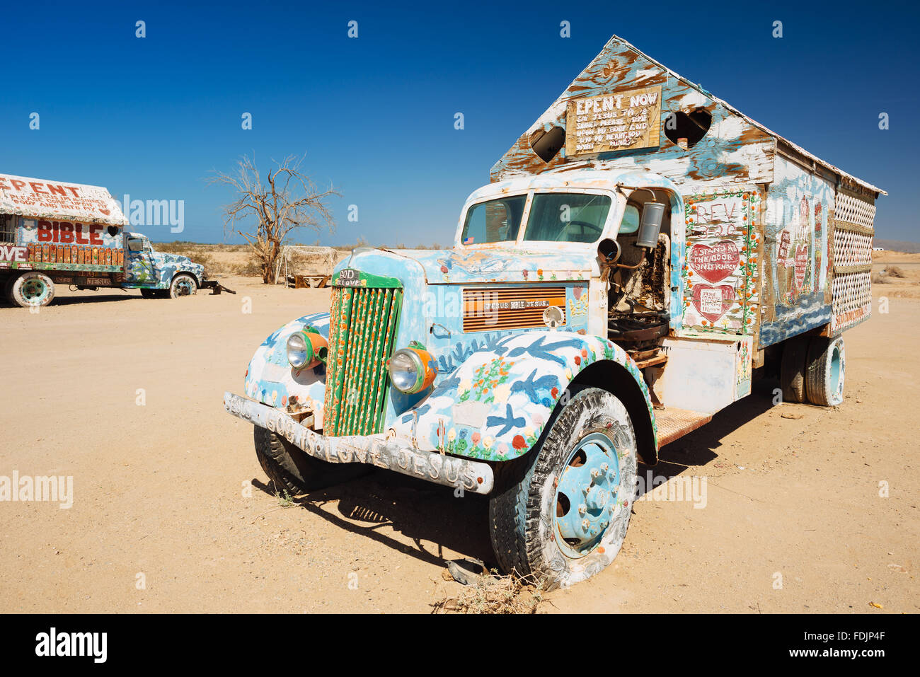 Trucks painted with religious slogans by Leonard Knight, the creator of Salvation Mountain in Slab City, California Stock Photo