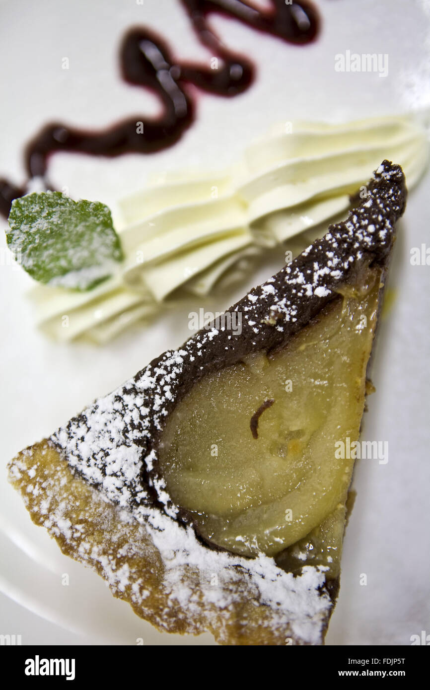 Pear, chocolate and walnut tart in the restaurant at Sissinghurst Castle Garden, Kent. Stock Photo