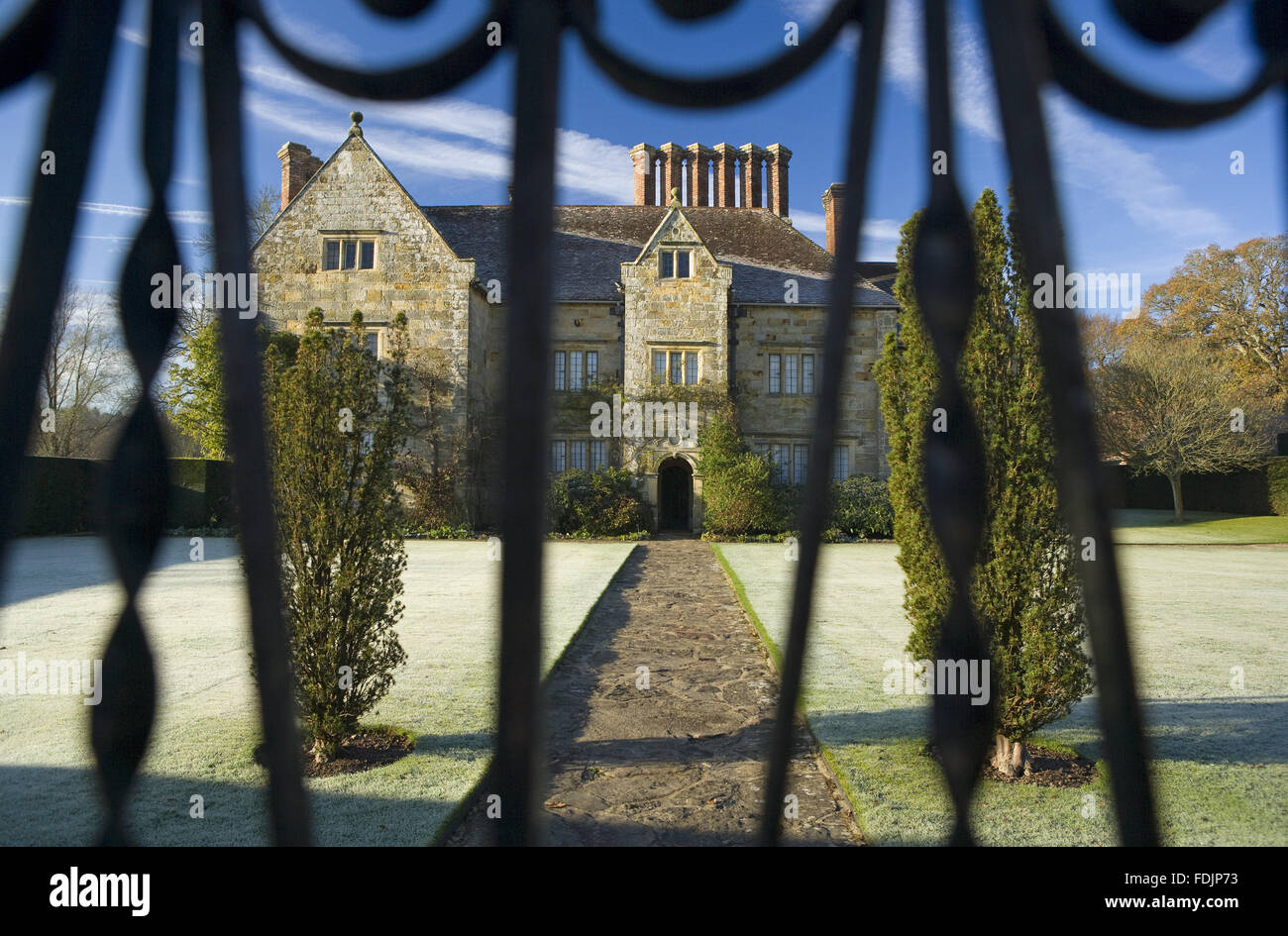 A view through the gate, on a frosty morning at Bateman's, Burwash, East Sussex. The Jacobean house was the home of author Rudyard Kipling, from 1902 to 1936. Stock Photo