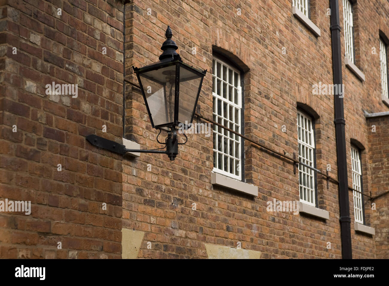 A lamp on the wall at Quarry Bank Mill, Styal, Cheshire. The mill was founded in 1784 and produced cotton until the 1950s. Stock Photo
