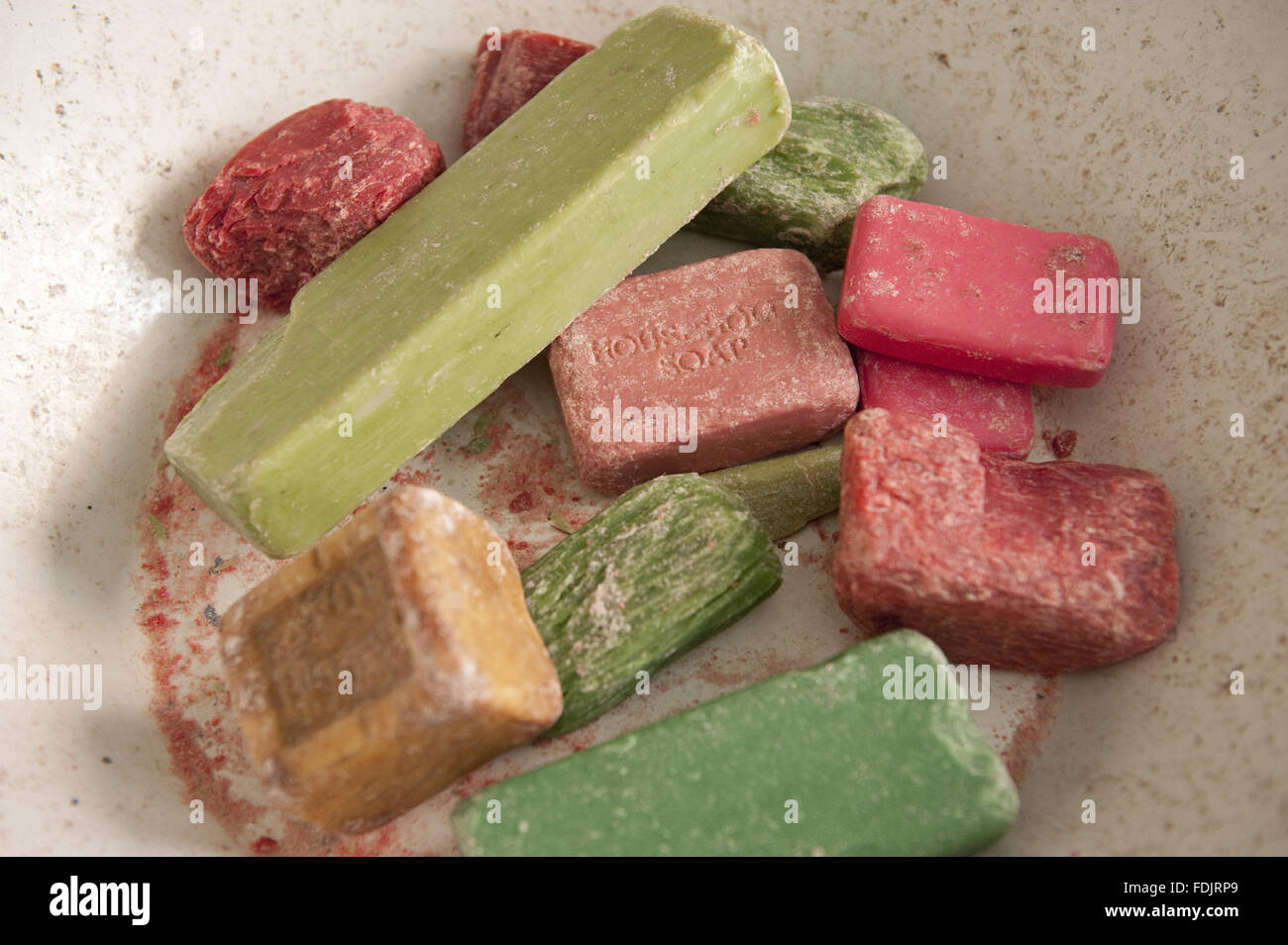 Old fashioned ends of soap in a bowl at the Birmingham Back to Backs. Stock Photo