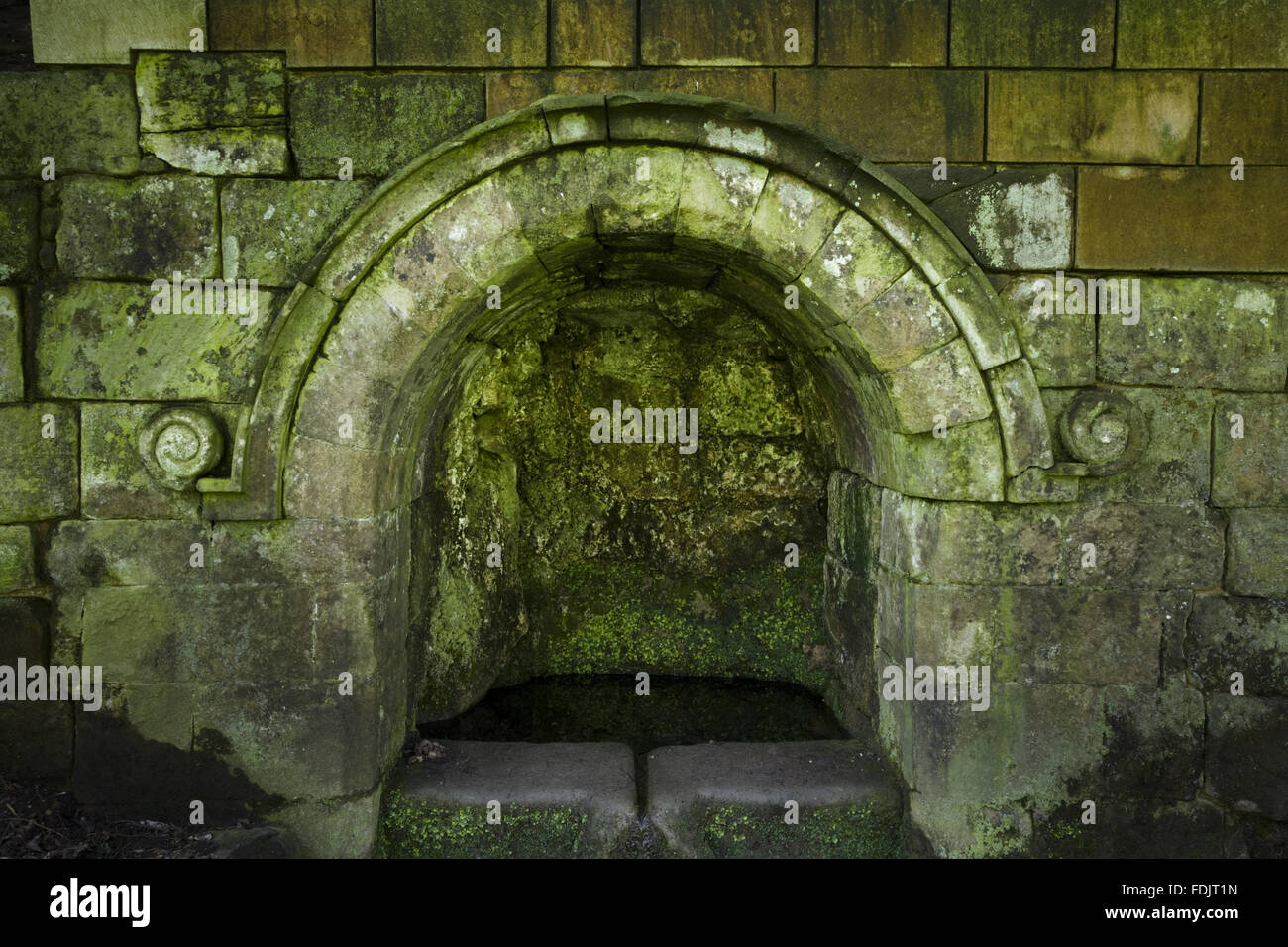 An arched recess containing a well at Fountains Abbey, North Yorkshire