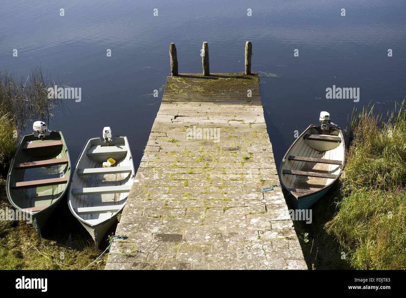 Boats moored against the slipway from the boathouse on Lough Erne at Crom, Co. Fermanagh, Northern Ireland. Stock Photo