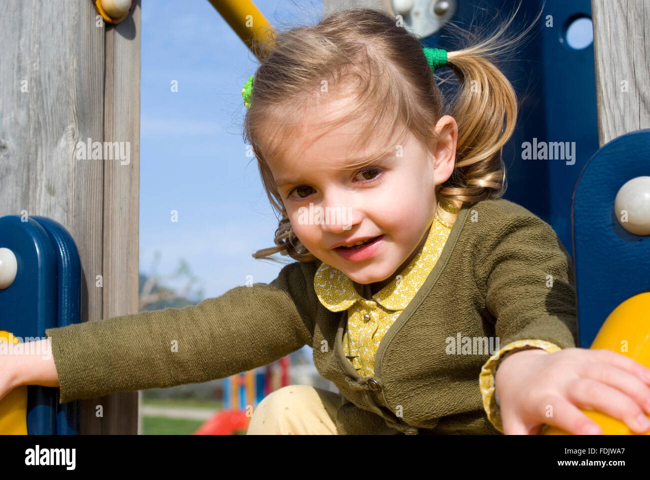 Girl on slide in playground Stock Photo - Alamy