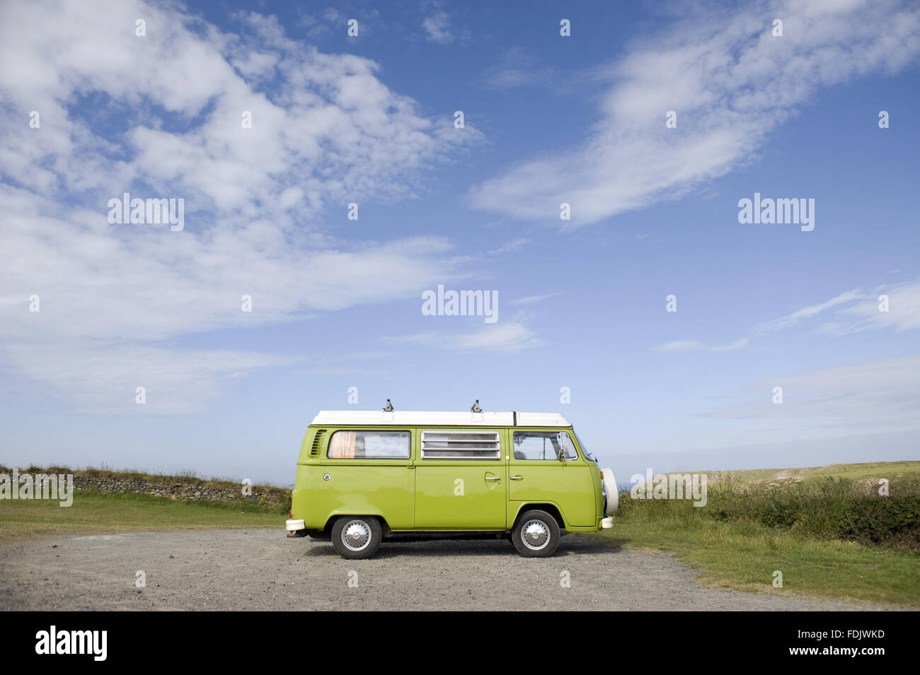 A VW campervan parked on the cliff at Kynance Cove, Cornwall. Stock Photo