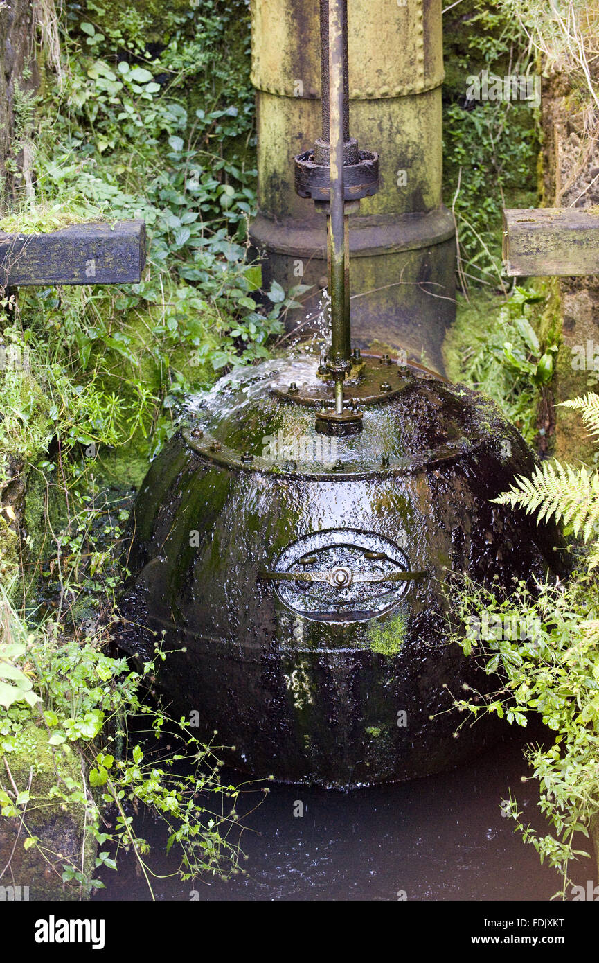 Old boiler now used as a water feature in the garden at Patterson's Spade Mill, Co. Antrim, Northern Ireland. The mill in Templepatrick is the last working water-driven spade mill in daily use in the British Isles. Stock Photo