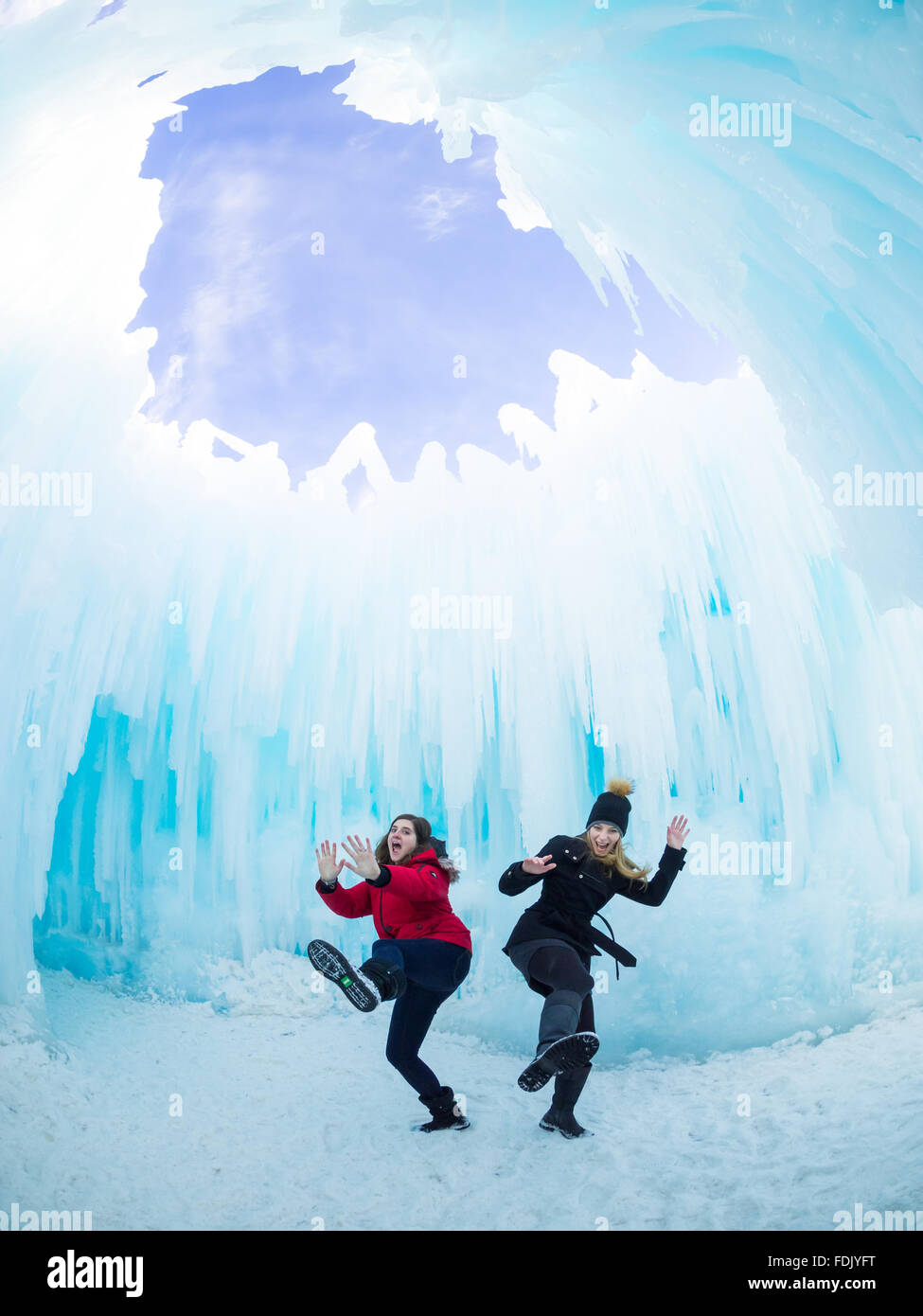 Two girls acting silly under the Dome Room at the Ice Castle in Hawrelak Park, Edmonton, Alberta, Canada. Stock Photo