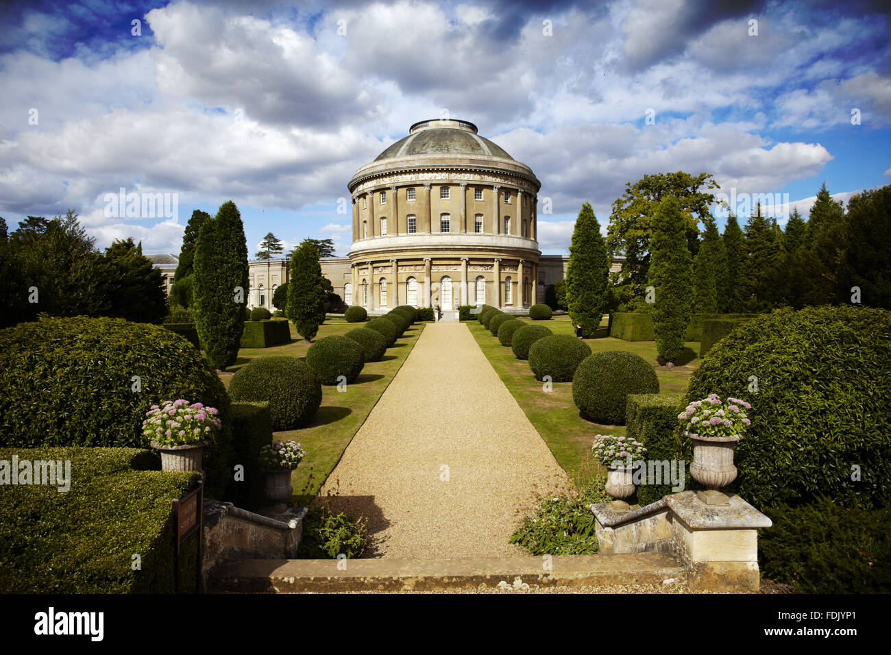 View through the Italianate Garden to the Rotunda at Ickworth, Suffolk. The house was started in 1795 but not completed until 1830, with a  domed Rotunda with classcial columns and friezes and curving corridors linking rectangular wings on either side. Stock Photo