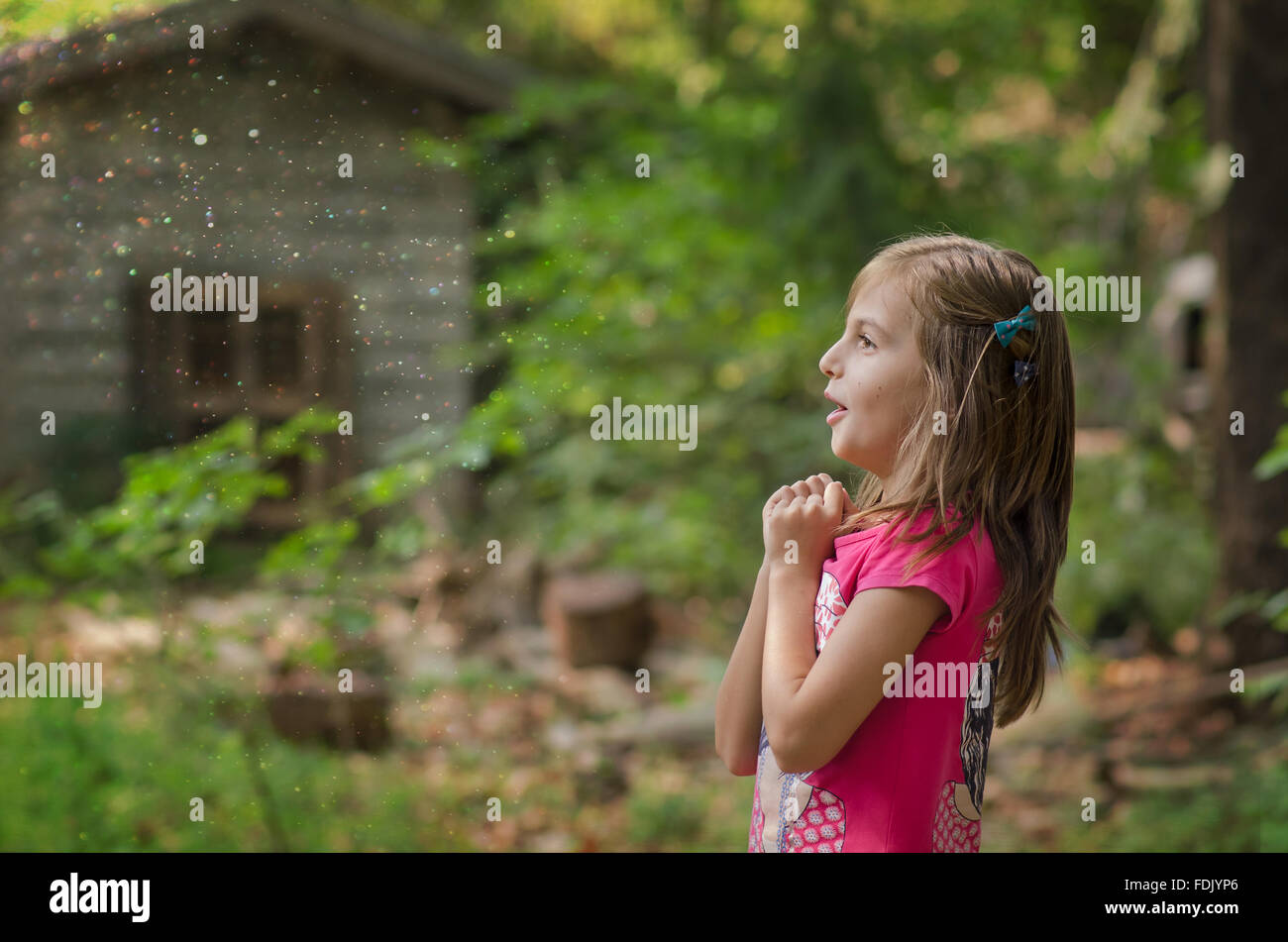 Surprised girl standing in a forest Stock Photo