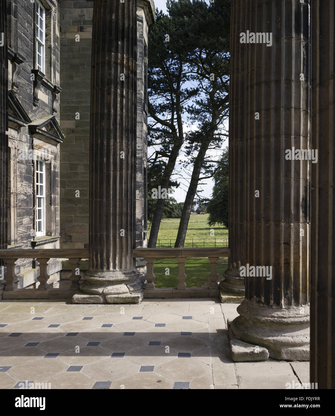 A view through the columns of the portico at Seaton Delaval Hall, Northumberland. The house was built for Admiral George Delaval by Sir John Vanbrugh, between 1718 and 1728, in the English Baroque style. Stock Photo