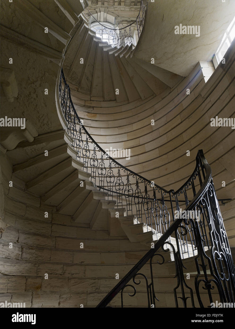 Stone spiral staircase at Seaton Delaval Hall, Northumberland. The house was built for Admiral George Delaval by Sir John Vanbrugh, between 1718 and 1728, in the English Baroque style. Stock Photo