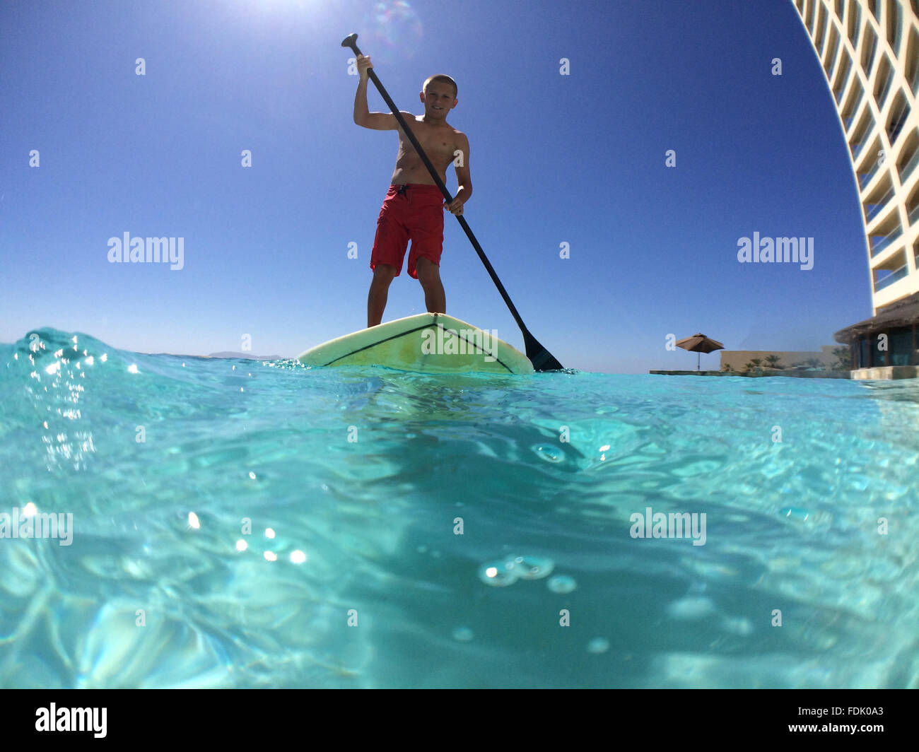 Boy paddleboarding Stock Photo