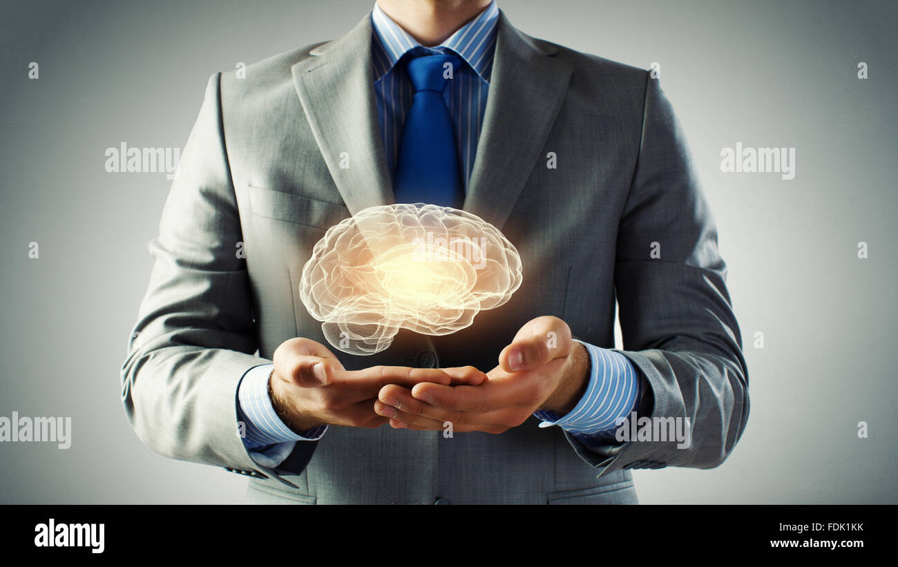 Close up of businessman hands holding brain in palm Stock Photo - Alamy