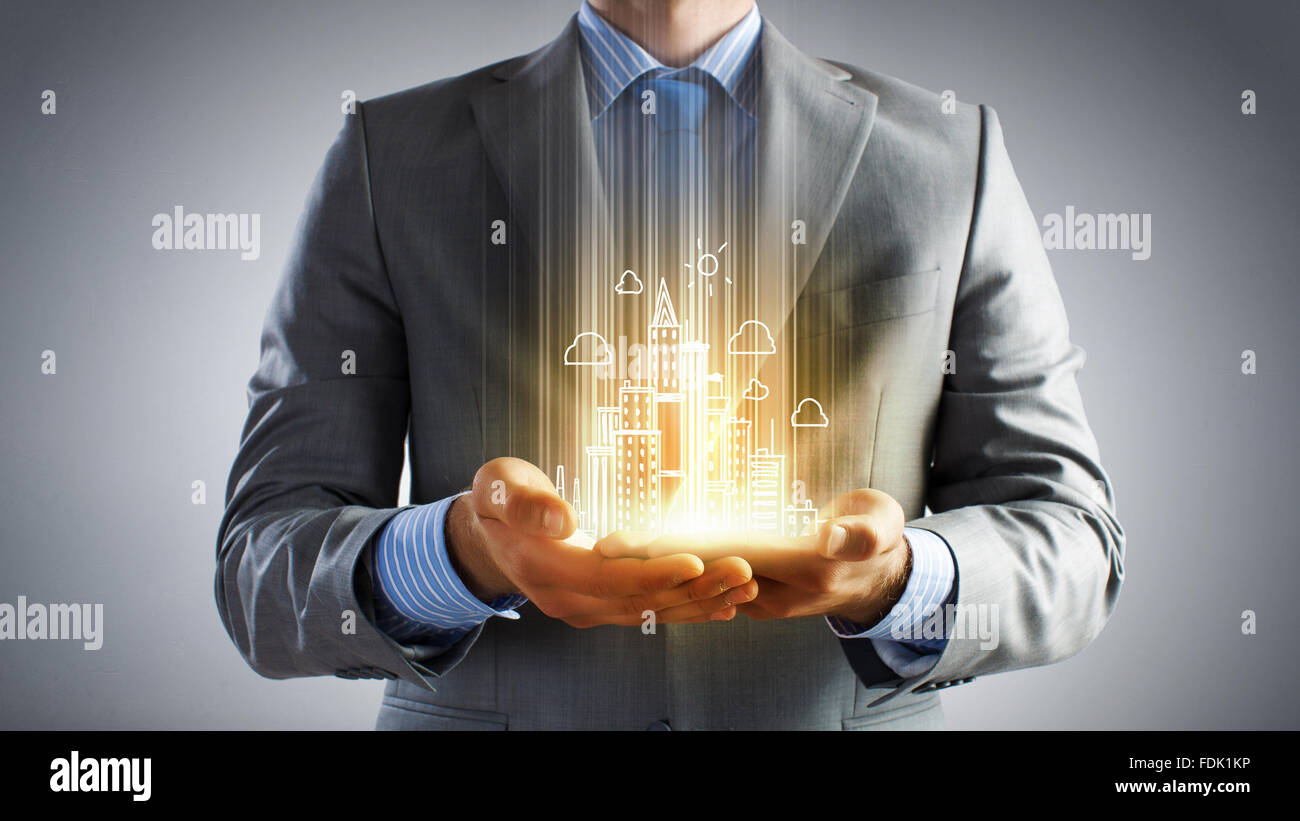 Hands of businessman and drawn building model in palms Stock Photo - Alamy