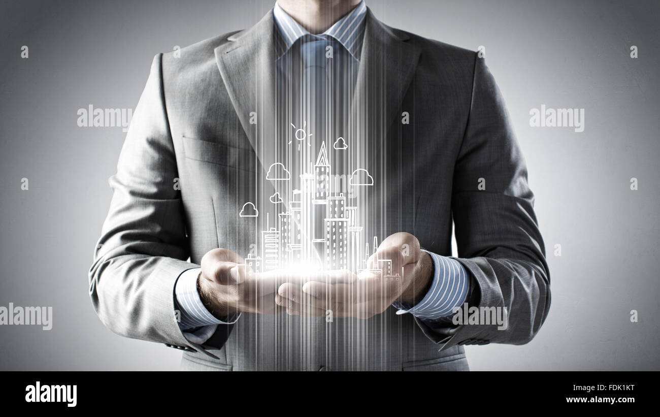 Hands of businessman and drawn building model in palms Stock Photo - Alamy