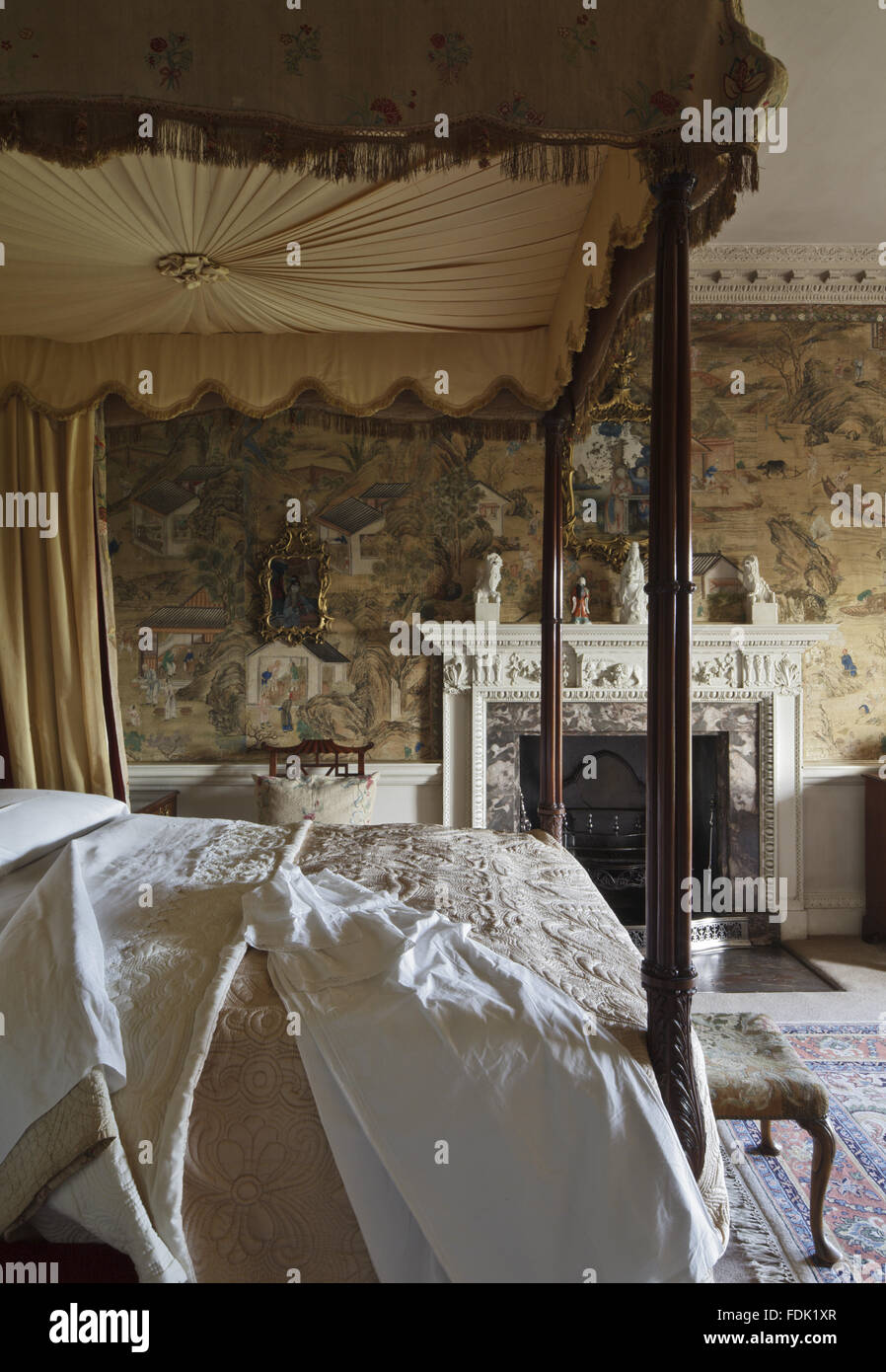 The Chinese Chippendale Bedroom at Saltram, Devon. The silk wallpaper is a 'factory' paper with scenes from everyday life in China. The mahogany four-poster bed, c.1760, was possibly supplied by Thomas Chippendale. Stock Photo