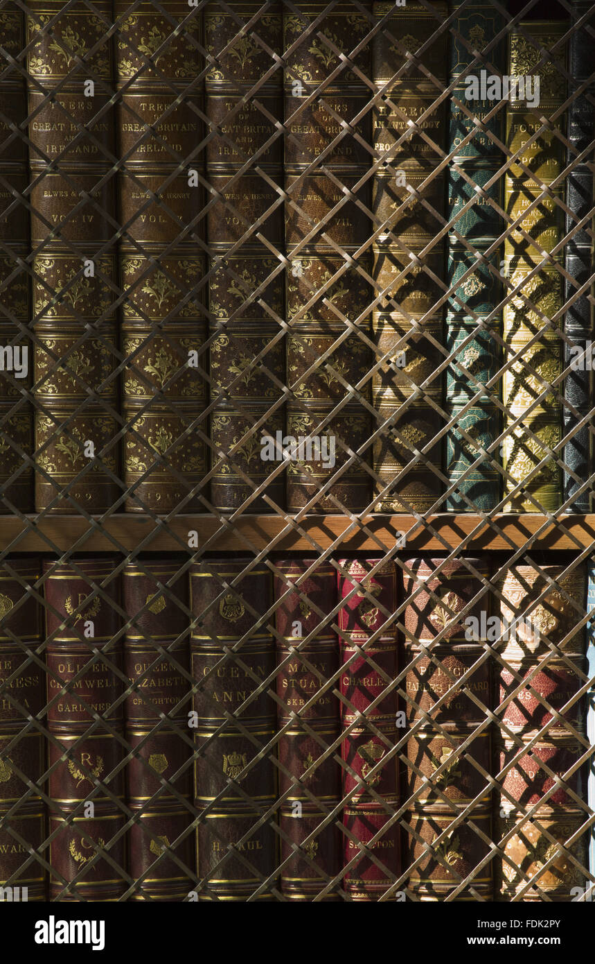 Leatherbound books on shelves in the Library at Anglesey Abbey