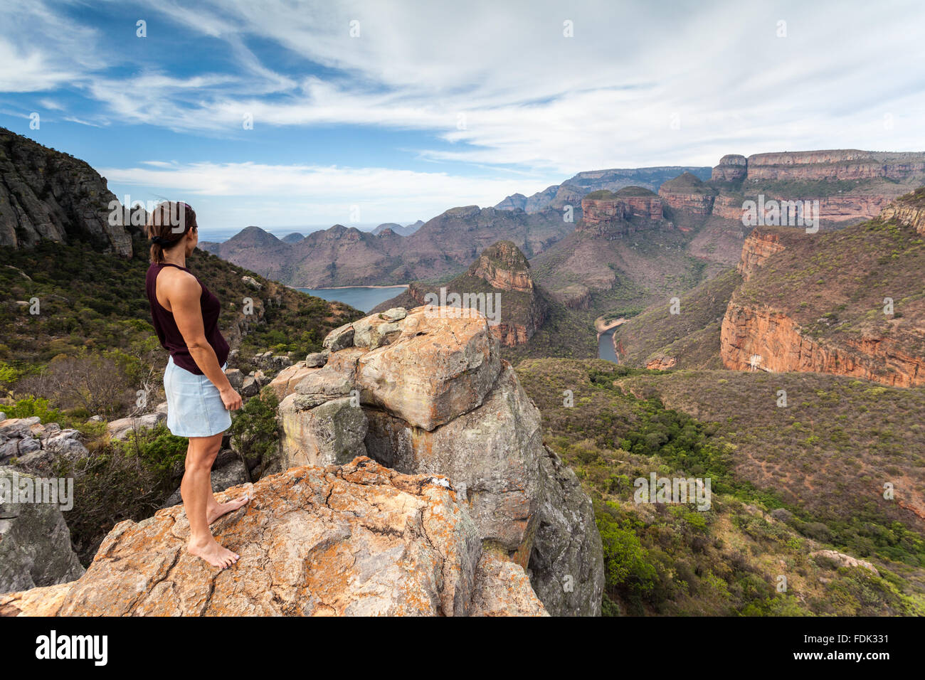 Woman looking at view of Blyde River Canyon and Drakensberg mountains, Mpumalanga, South Africa Stock Photo
