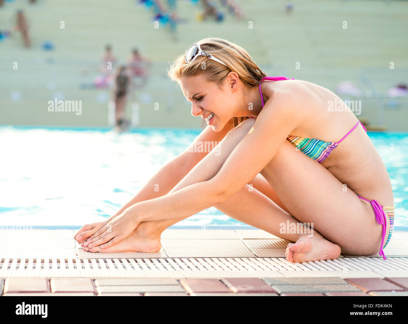 Young woman with injured leg Stock Photo